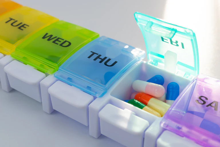 A weekly pill holder labelled with days of the week.