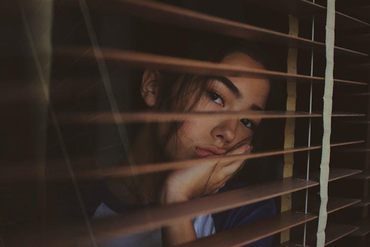 A woman stares out the window