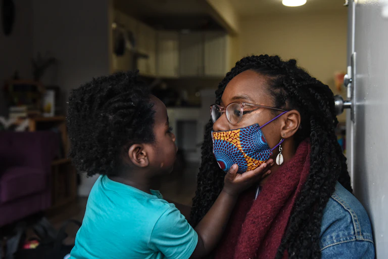 Sevonna Brown of Black Women's Blueprint, a mutual aid group, with her son in New York City. Mutual aid groups have formed in the city to address the economic plight caused by the pandemic.