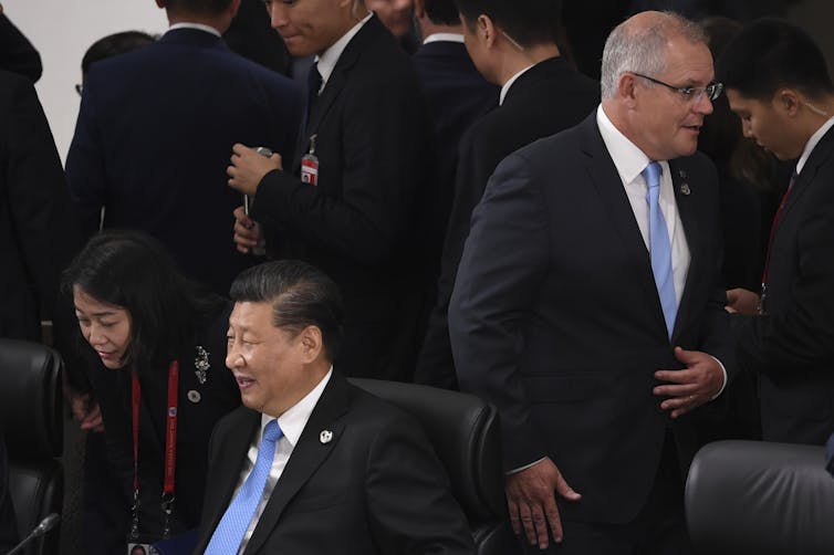 Scott Morrison walks past Xi Jinping at the G20 in June 2019.