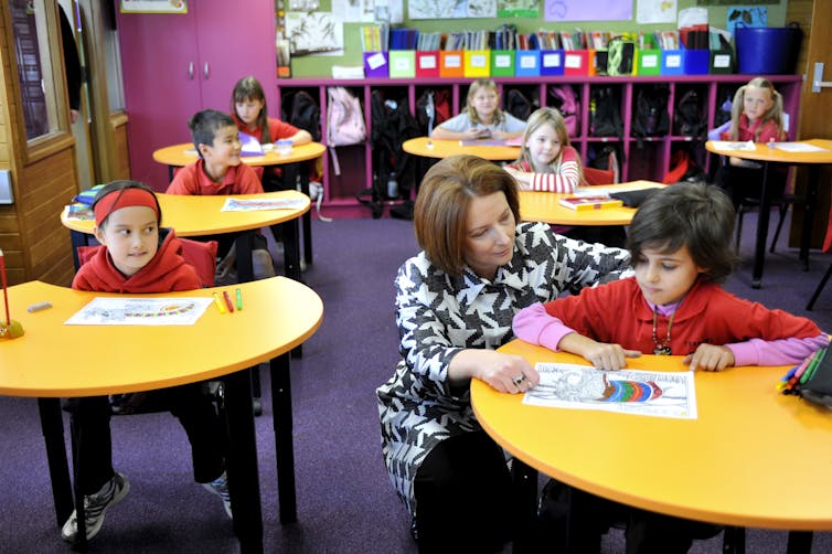 Julia Gillard with a student sitting the NAPLAN test.