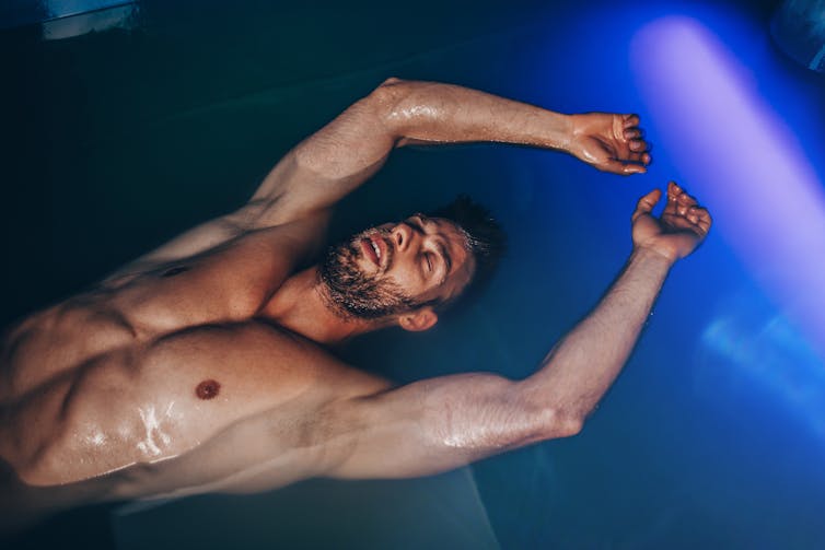 A man floating in a float tank