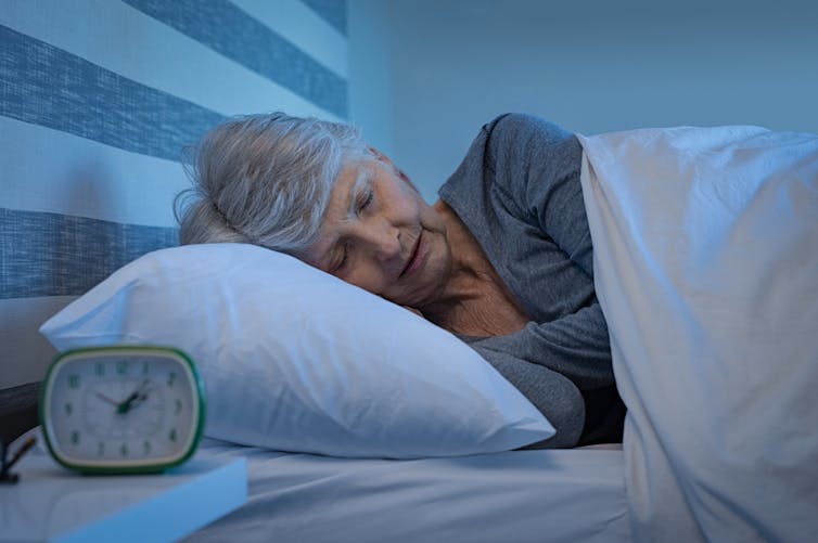 An elderly lady in bed sleeping