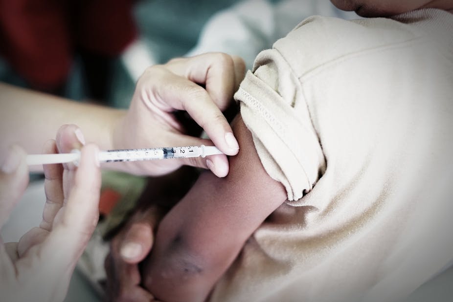 A doctor giving a vaccine injection to a person.