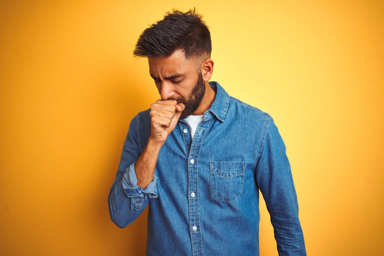 Man coughing into his hand