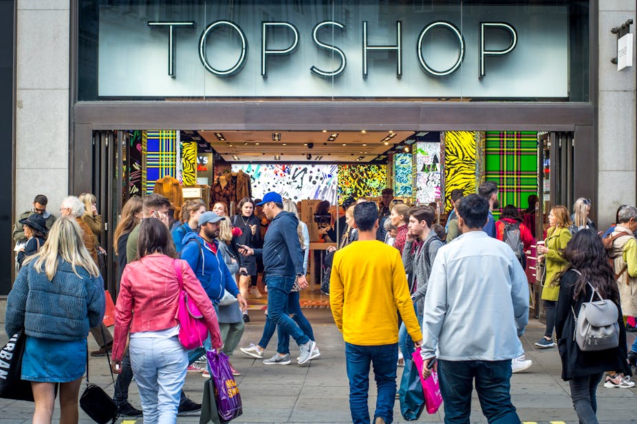 People entering and walking past Topshop.