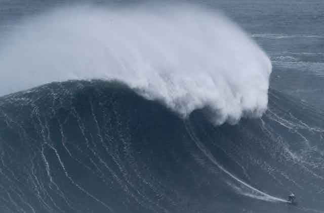 Maya Gabiera surfing a huge wave. 
