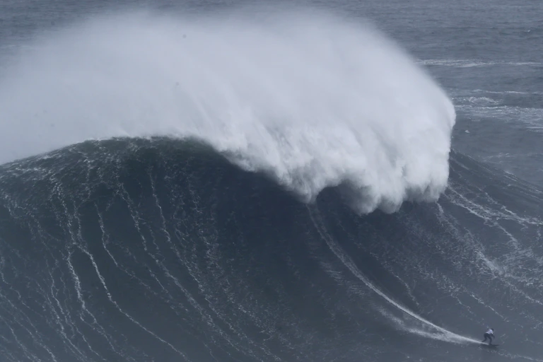 Maya Gabiera surfing a huge wave.