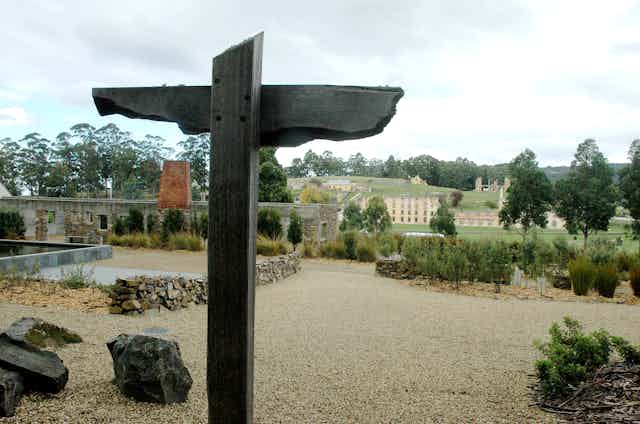 A wooden cross in front of Pt Arthur ruins