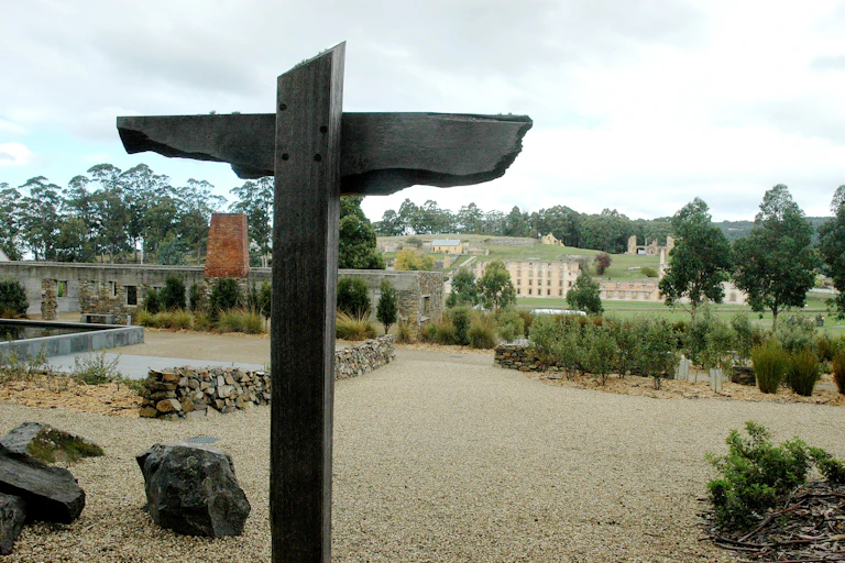 A wooden cross in front of Pt Arthur ruins
