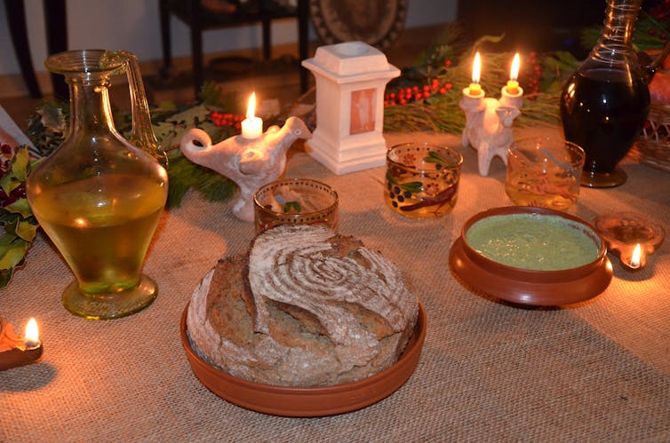 A table with food, wine and candles.