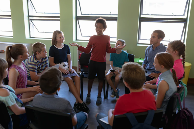 Group of teenagers sat in a circle