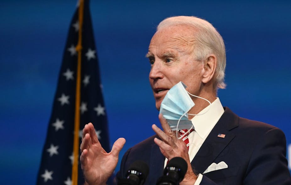 Joe Biden shows a mask at a press conference on November 16.