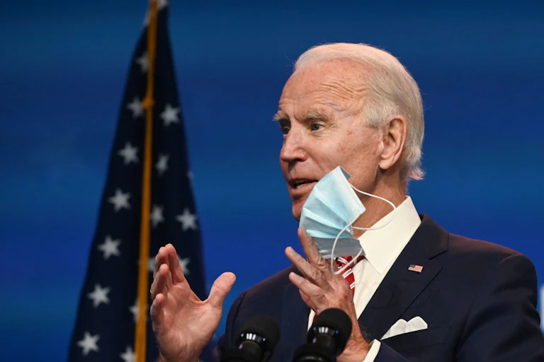 Joe Biden shows a mask at a press conference on November 16.