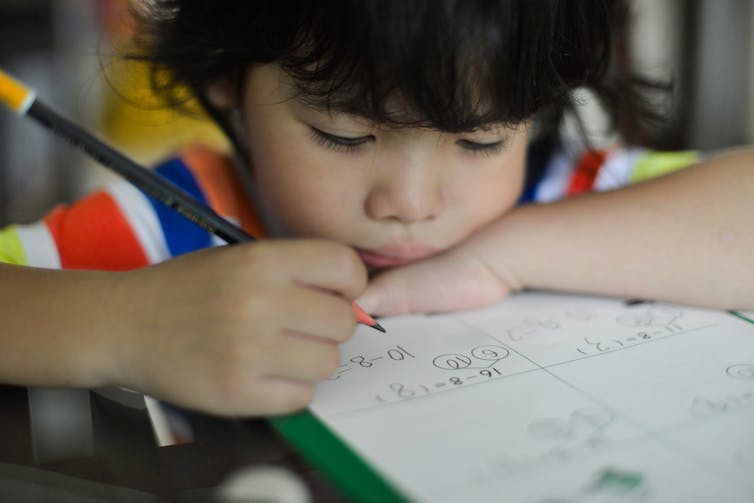 Young boy doing maths homework