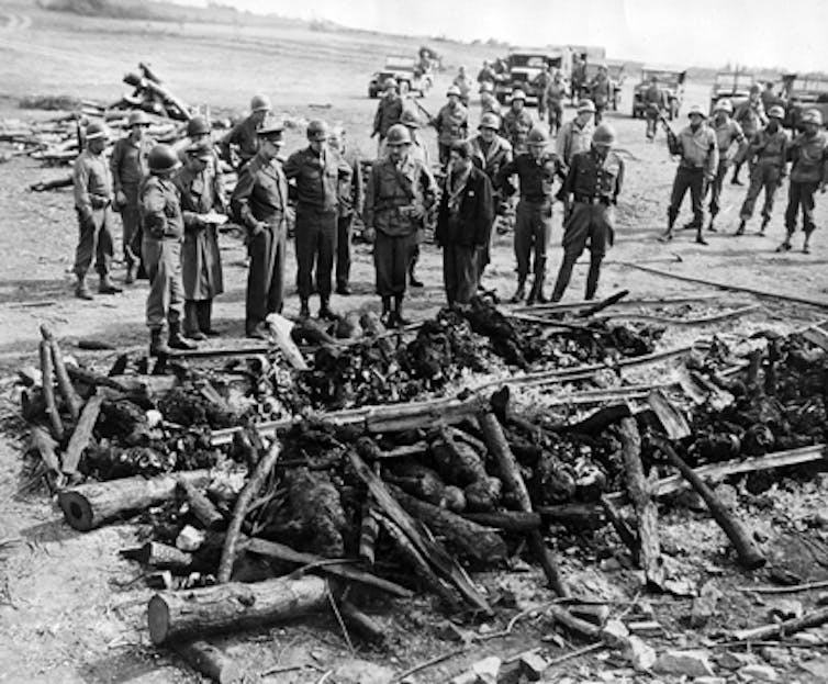 General Eisenhower views the views the charred bodies of prisoners at Ohrdruf concentration camp
