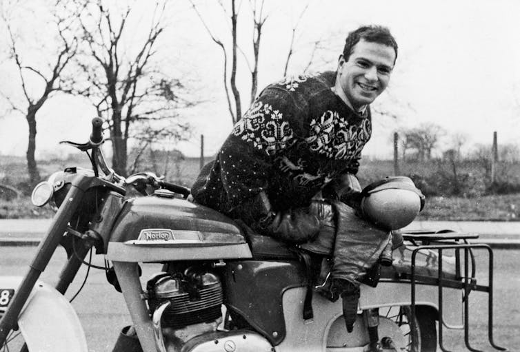 Young man with motorbike in retro black and white photo