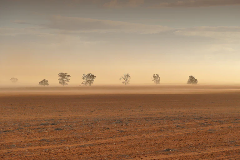 Dust storm on a dry, brown farm