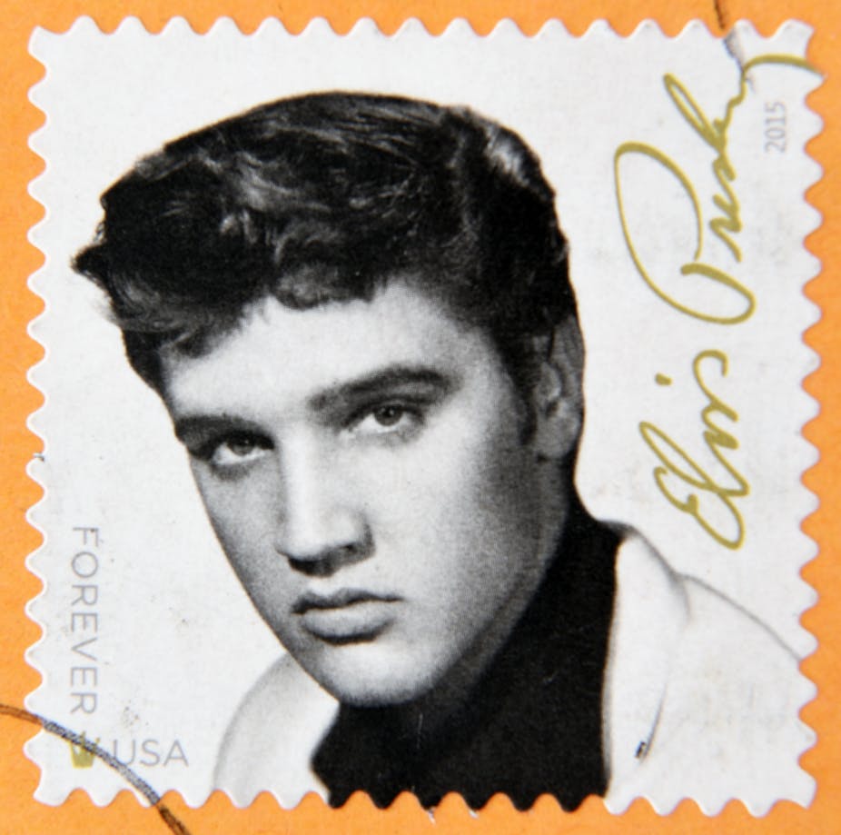 Black and white stamp of Elvis Presley on orange background