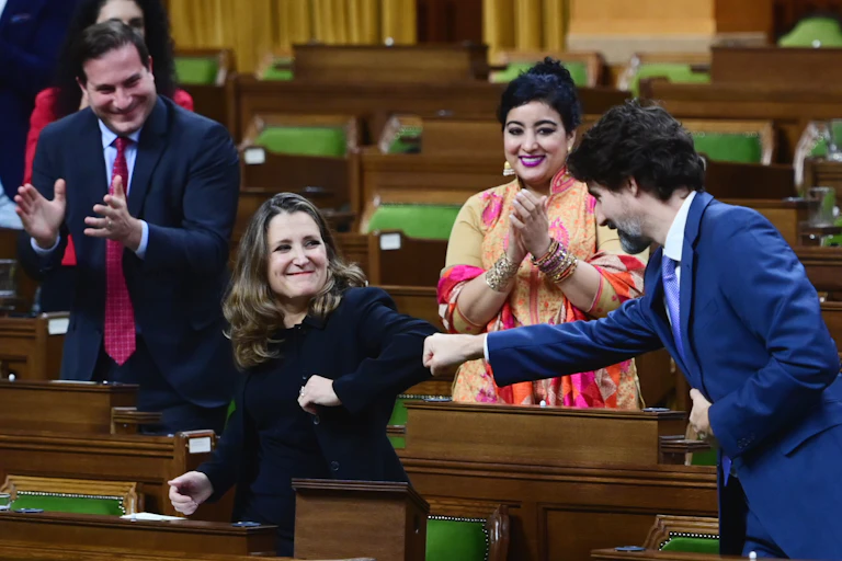 Justin Trudeau fist-bumps Chrystia Freeland's elbow.