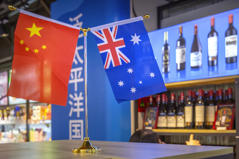 A visitor wearing a face mask to protect against the coronavirus looks at a display of Australian wines at the China International Import Expo (CIIE) in Shanghai
