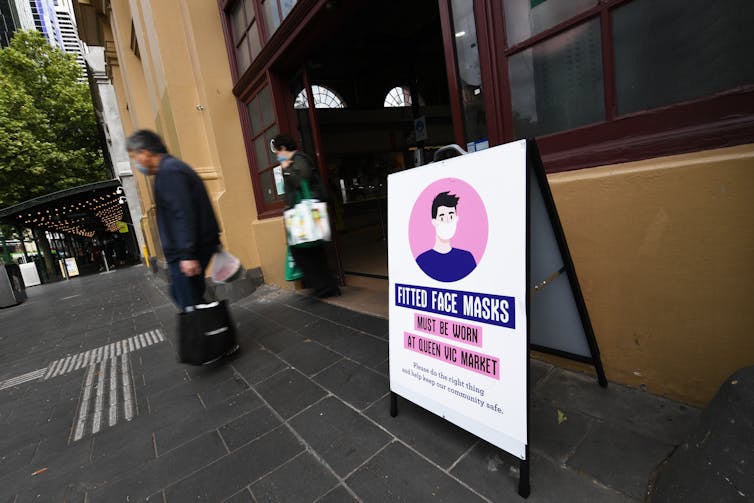 A sign in Victoria outside Queen Victoria market noting face masks are compulsory.