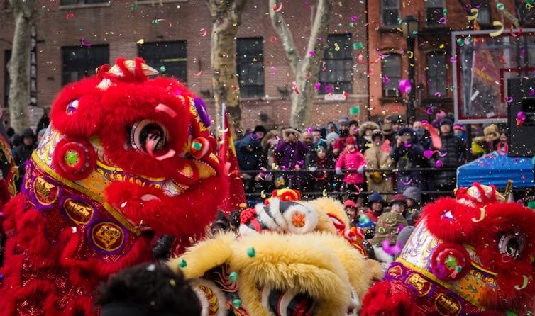 Crowds watching a lion dance during Lunar New Year.