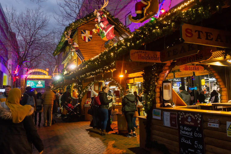 Brightly lit stalls at night.