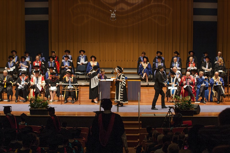 university leaders on stage during graduation ceremony