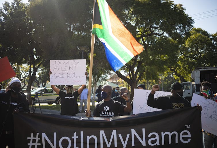 Protesters with a South African flag and Black Lives Matter banner at the US embassy in Pretoria, South Africa, June 2020.