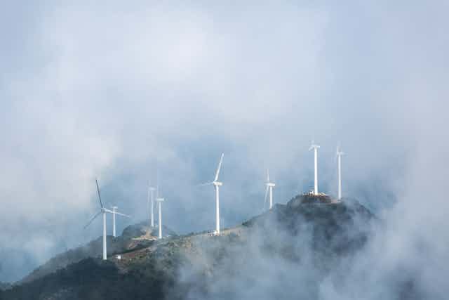 Wind turbines on a misty hillside