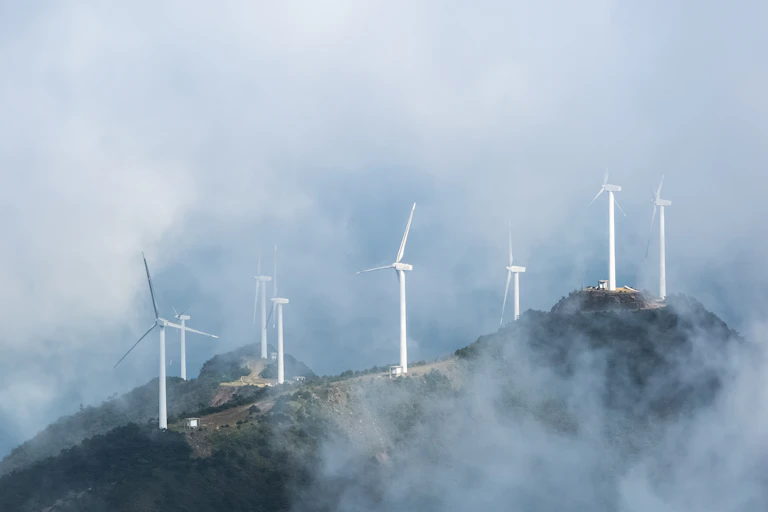 Wind turbines on a misty hillside