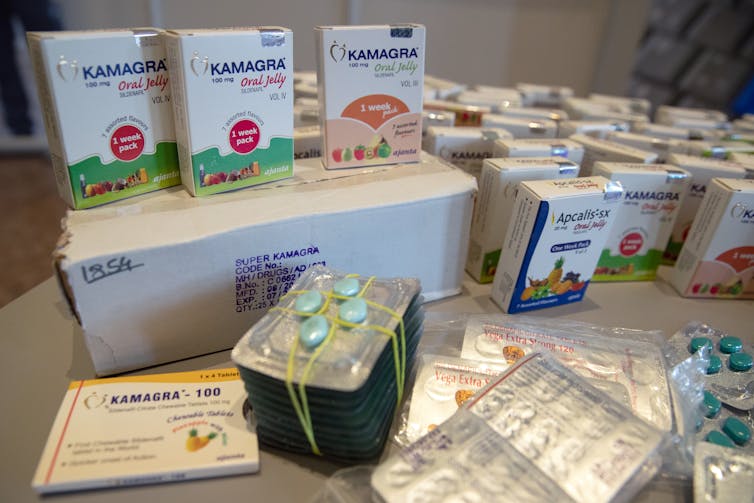 A collection of counterfeit medicines sit on a table at the ministry of finance in Berlin
