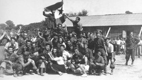 Soldiers posing for a photo during the liberation of a concentration camp.