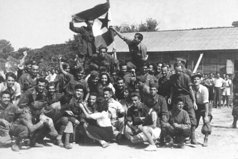 Soldiers posing for a photo during the liberation of a concentration camp.