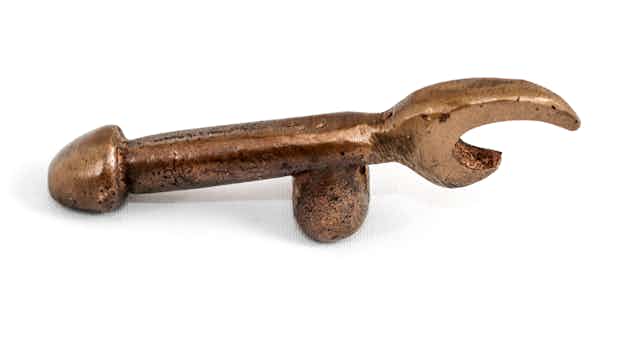 A brass bottle opener doubles as a phallic symbol.