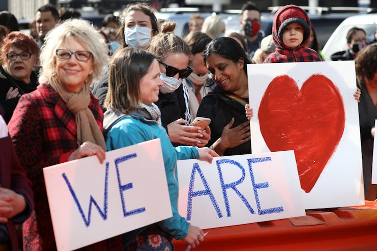 People holding signs