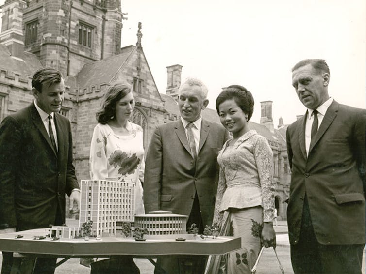 Harold Maze and four other people looking at a model of a building.