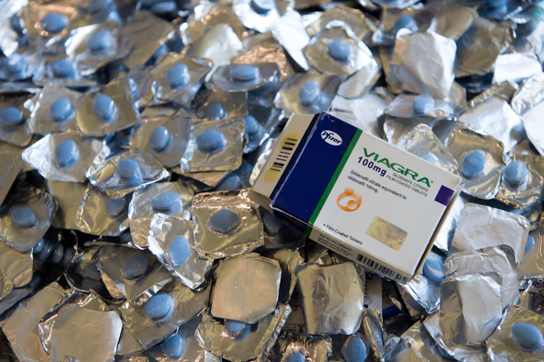 A box of counterfeit viagra sits upon a pile of counterfeit pills