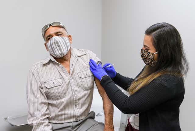 Juan Miranda receives a flu shot at the Family Health Clinic of Monon in Monon, Indiana.