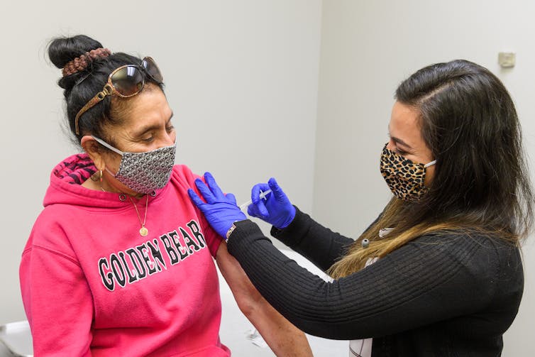 Elidia Miranda receives a flu shot at the Family Health Clinic of Monon in Monon, Indiana.