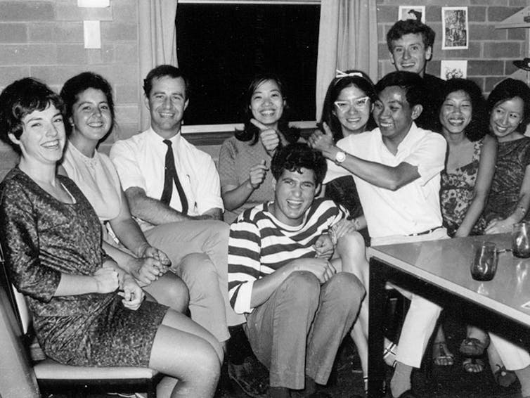 A group of people sitting and laughing.