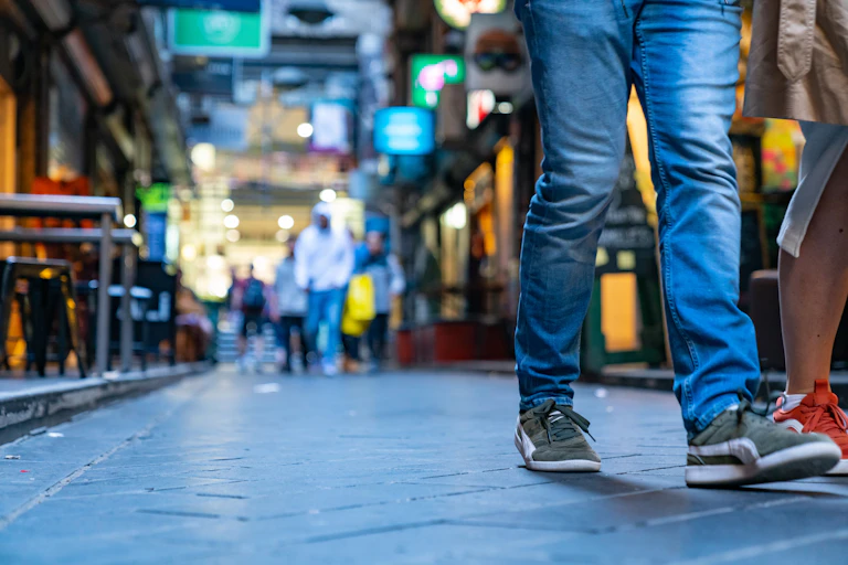 pavement level view of people walking down laneway
