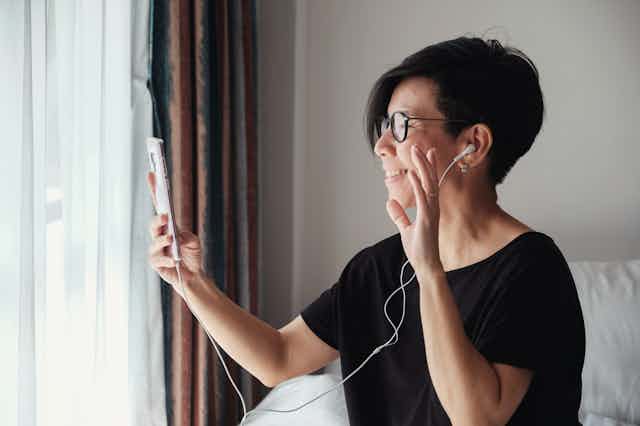 A woman uses her phone to video chat.