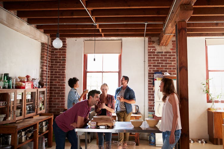 A group of young people socialising in someone's home.