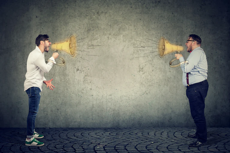 Two men shouting at each other through loud hailers