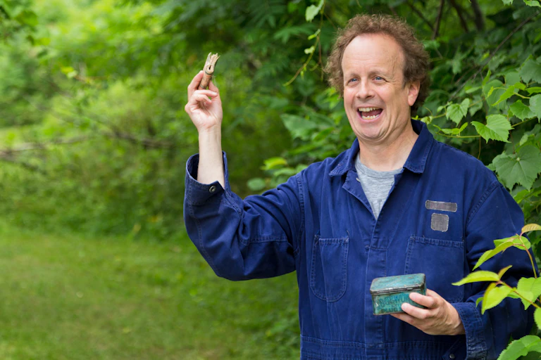 A man holds up a wad of money.