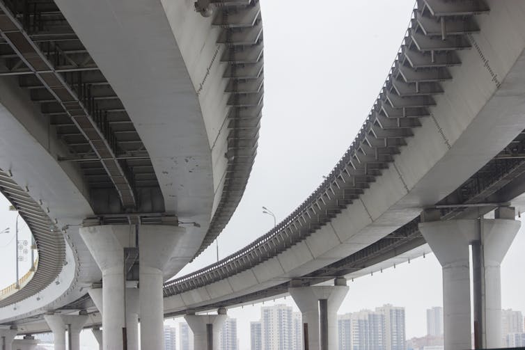 A concrete highway bridge viewed from below.