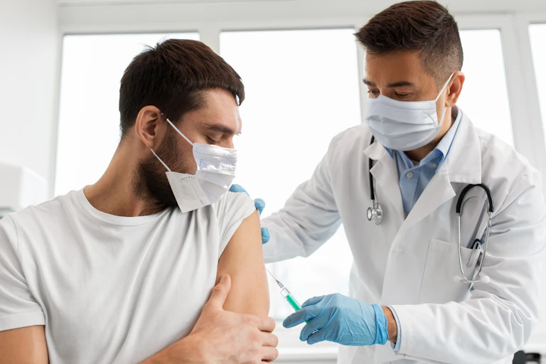 A nurse administering a vaccine to a man
