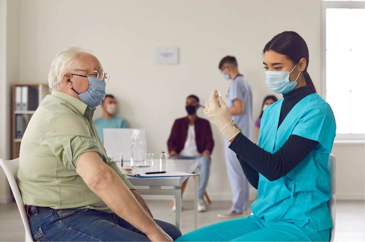 An older man getting vaccinated